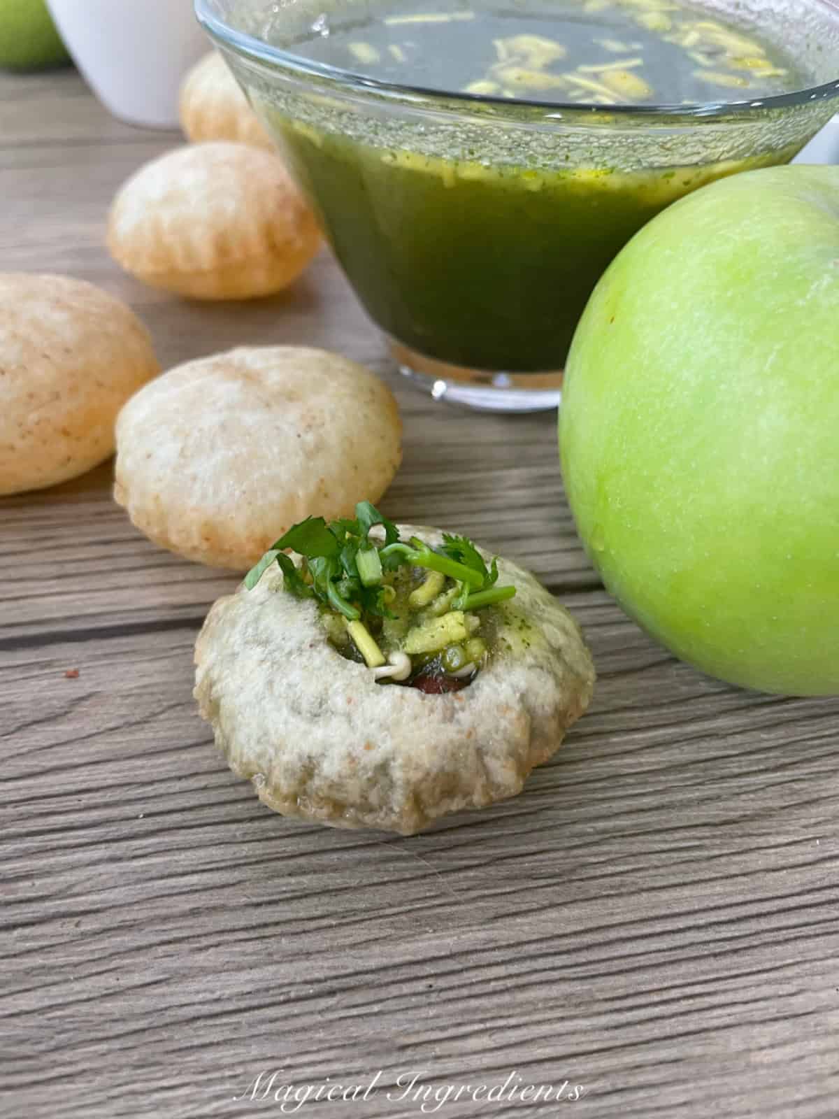 puri filled with apple pani, garbanzo, and potato