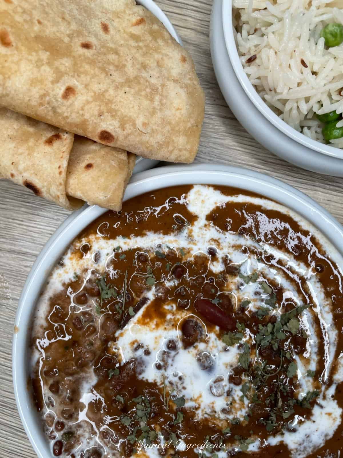 Close view of dal makhni along with rice and roti