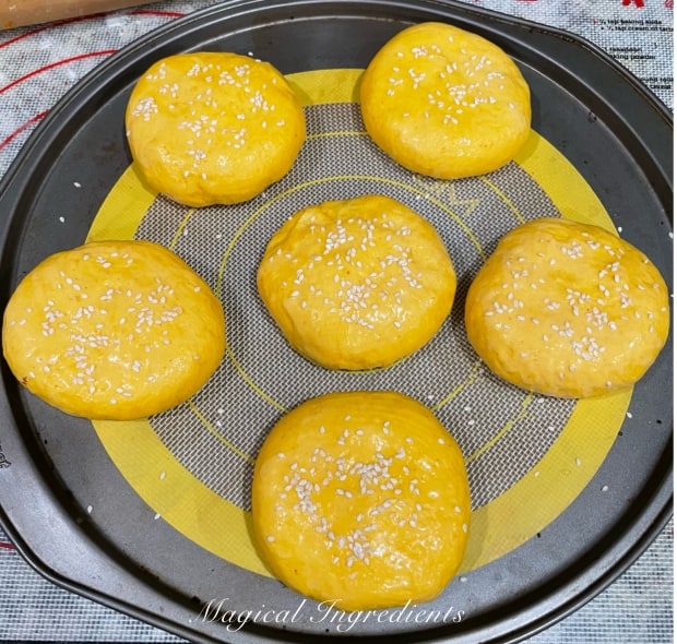 Brushing with aquafaba and sprinkling with sesame seeds