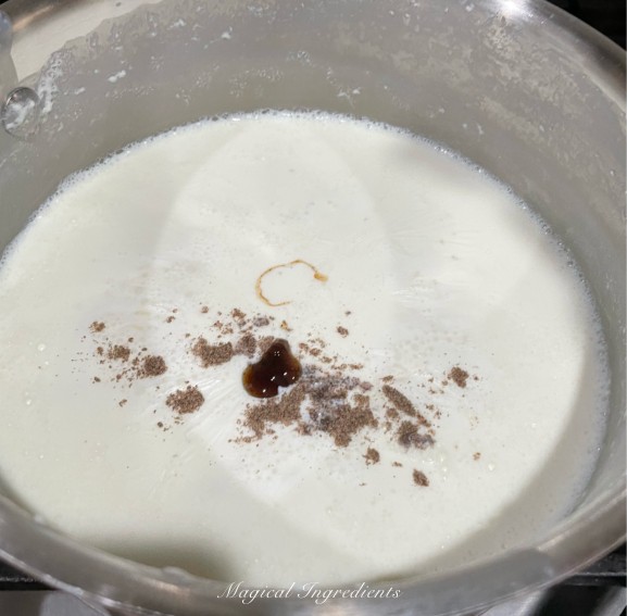 adding cardamom powder and vanilla extract paste