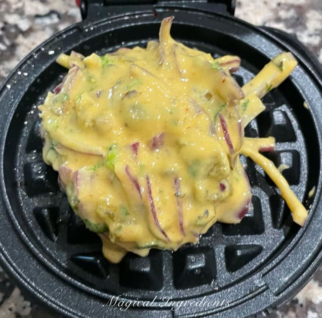 adding the batter to the waffle iron