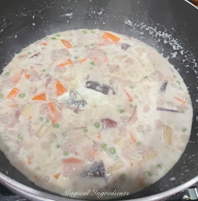 adding the almond-Thai chili mixture and simmering