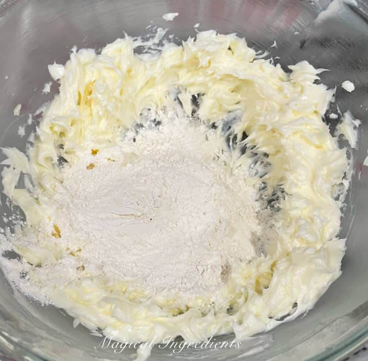 adding dry ingredients to creamed butter