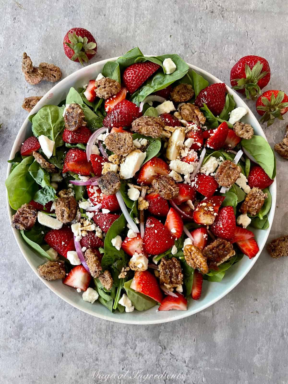 a bowl of strawberry spinach salad